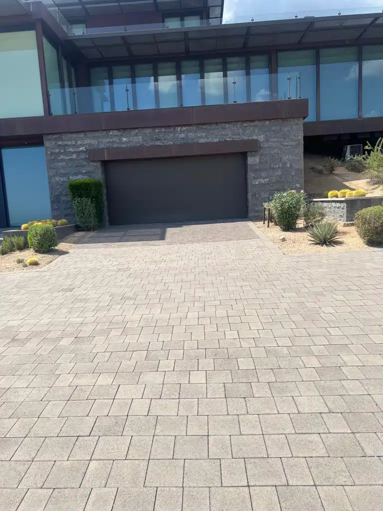 The same paver driveway after cleaning, viewed toward the home